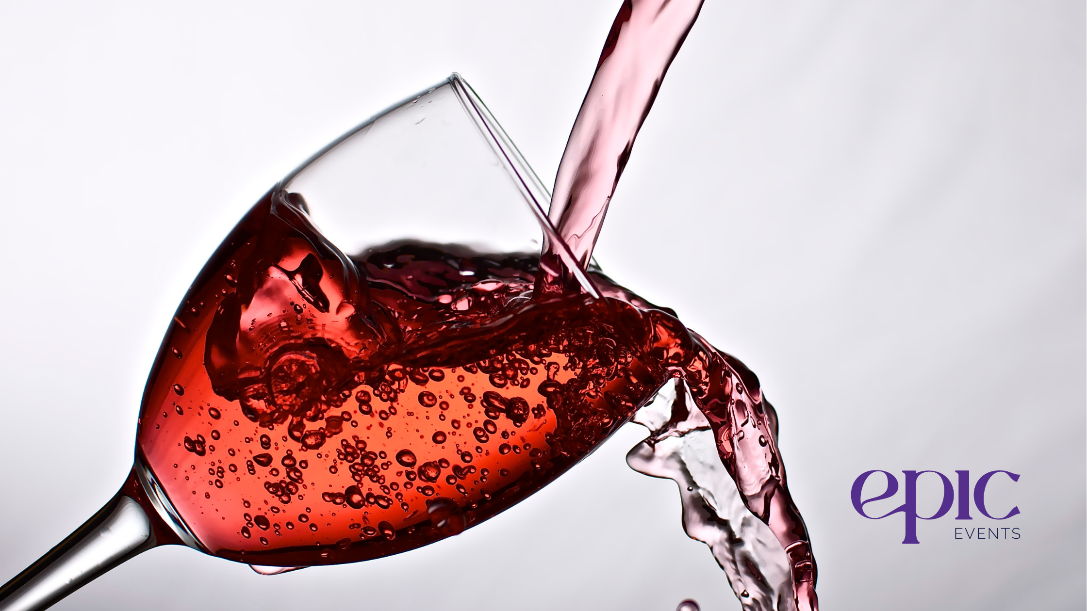 A glass of red wine being poured, symbolizing the evolving trends in event beverage offerings, including the shift towards premium non-alcoholic alternatives.