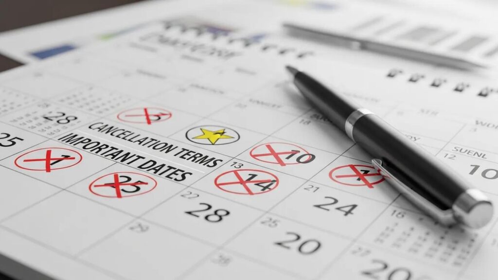 Calendar highlighting important cancellation dates with marked penalties and a pen, emphasizing event planning and attrition terms.